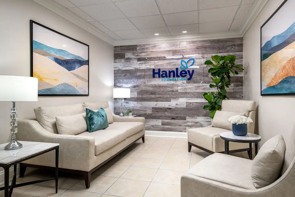 Reception lounge with the Hanley logo on a wood wall