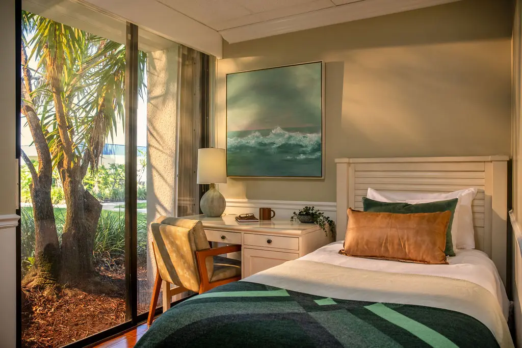 Bedroom in the men’s residential program with a garden view